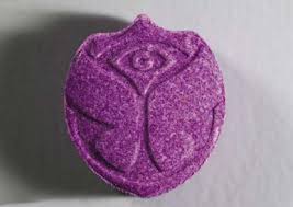One purple MDMA Pill surrounded by many colorful MDMA Pills also known as molly, premium quality from Psychedelic Deals