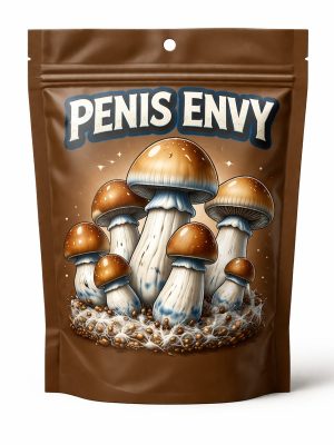 Brown plastic bag containing dried Penis Envy magic mushrooms with bold white "Penis Envy" text and Penis Envy mushroom illustration on the packaging.